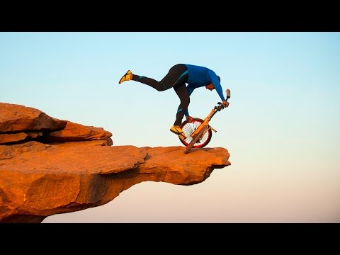 Clifftop BMX Yoga: Extreme 68-year-old Performs On Bike 300ft Above Ground