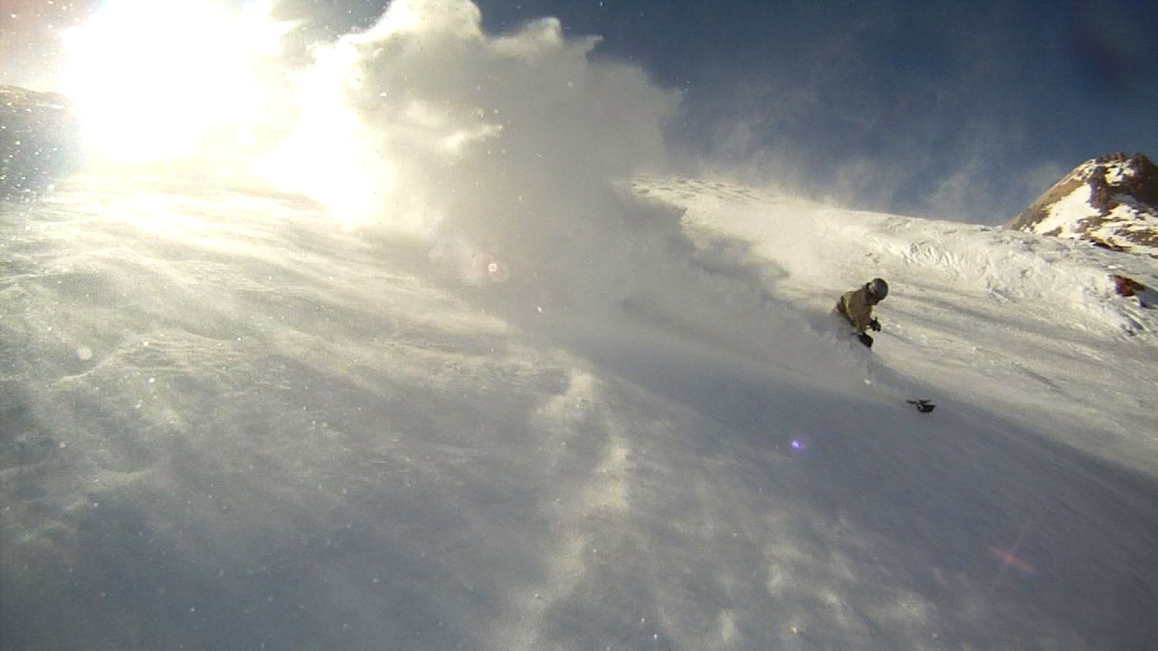 powder skiing and snowboarding on wind buff.