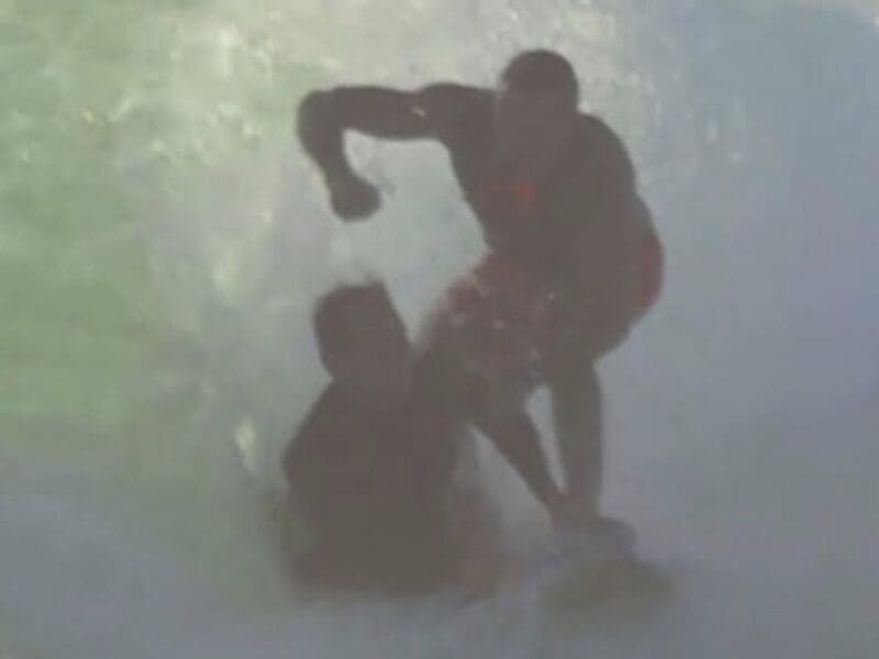 Surfers get scrappy on crowded wave.