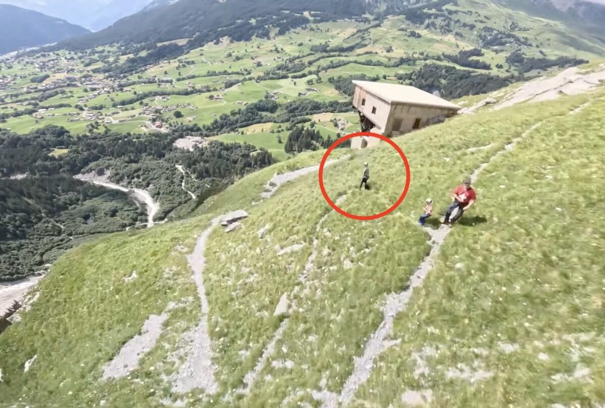 Hiker mid-bathroom break is passed by a BASE jumper.
