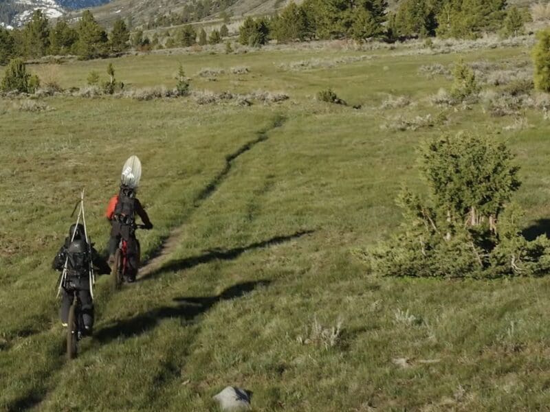 Jeremy Jones and Elena Hight biking into the mountains.