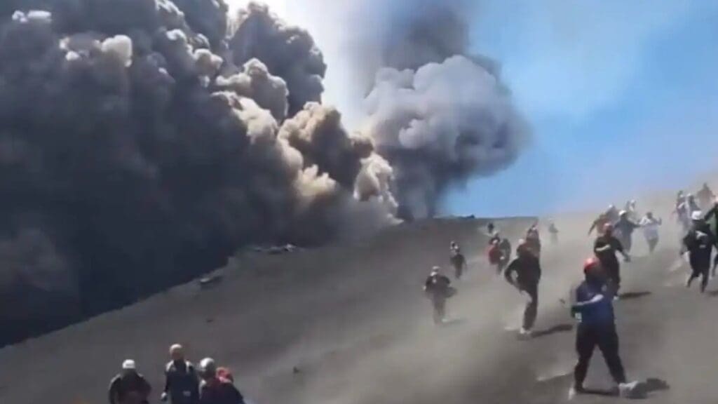 Tourists run for their lives on an eruption Mt. Etna.