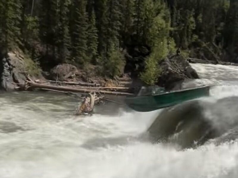 Jet boat launches over waterfall.