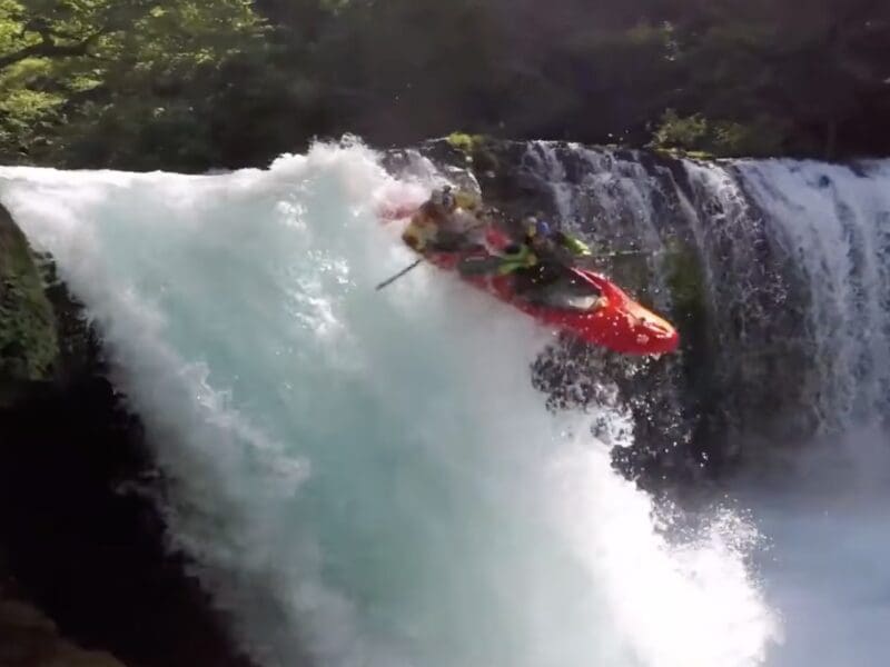 Tandem kayakers send a 40 foot waterfall.