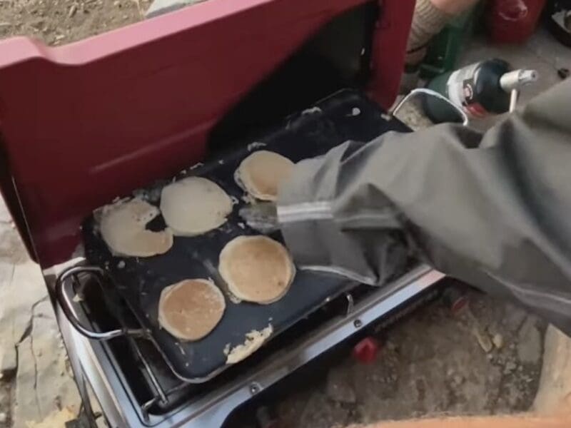 TrailswithZach cooks pancakes at the top of Mount Timpanogos.