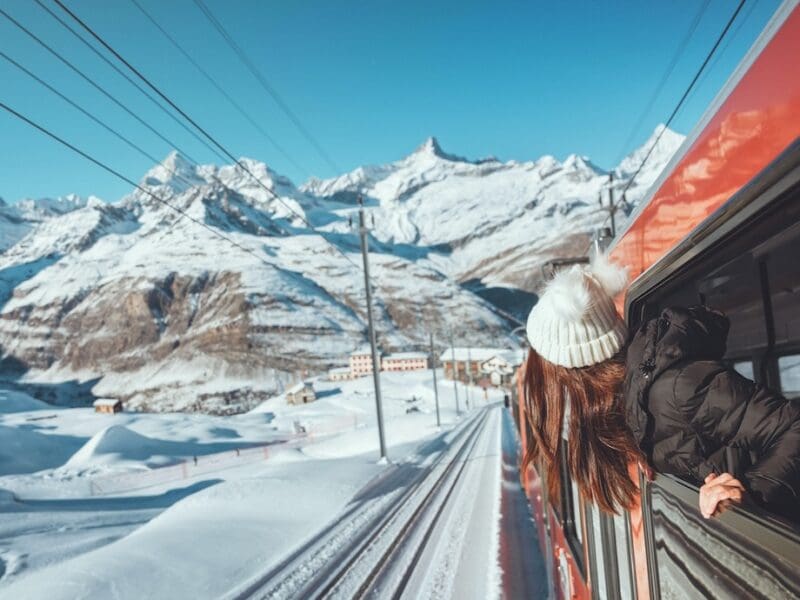 Woman on ski train in the alps with snowy mountains