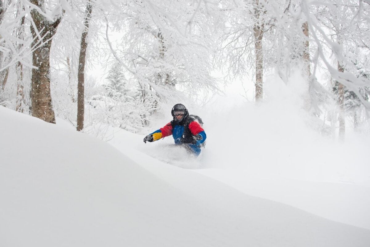 Snowboarder in deep snow in Jay Peak