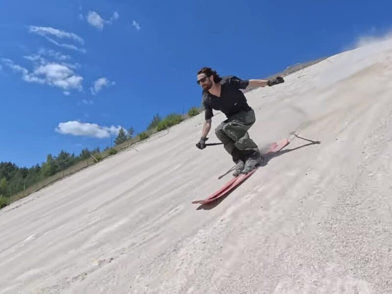 Alex Hackel skis on sand.
