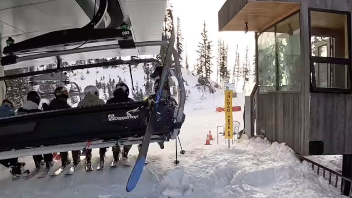 Flying ski strikes snowboarder on the chairlift behind.