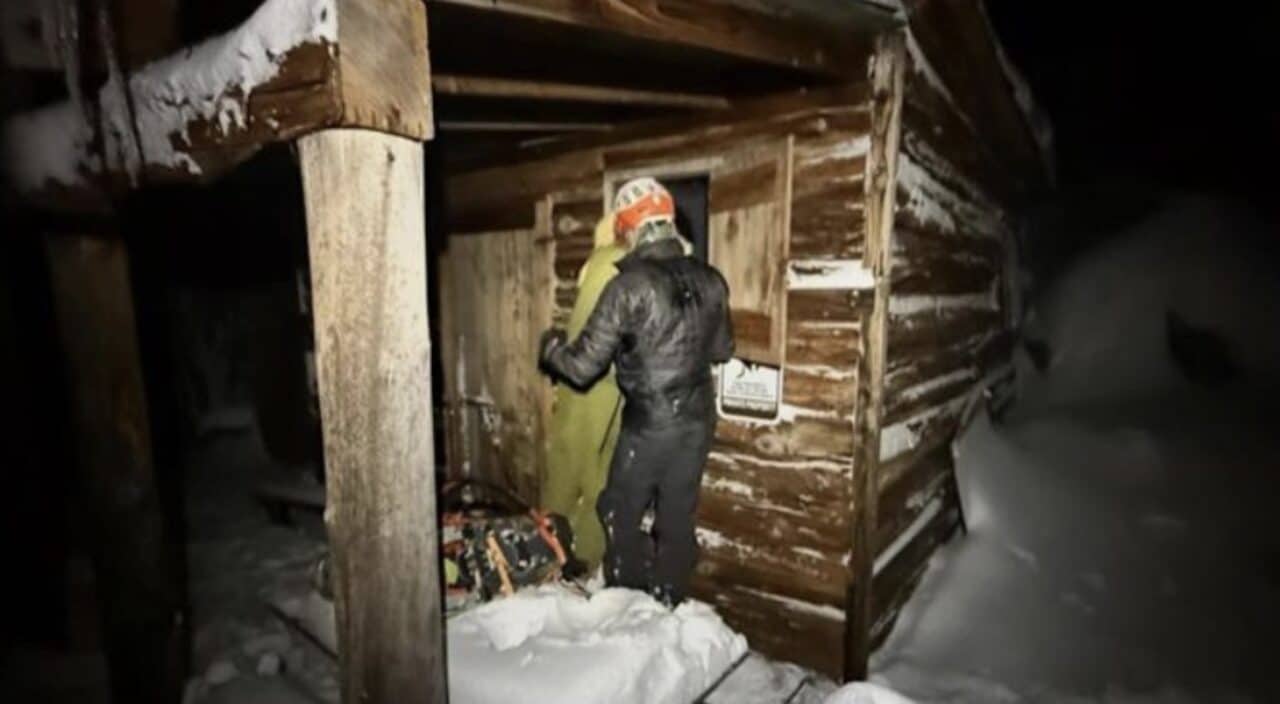Rescue crews assist a snowboarder who took refuge in an abandoned cabin.