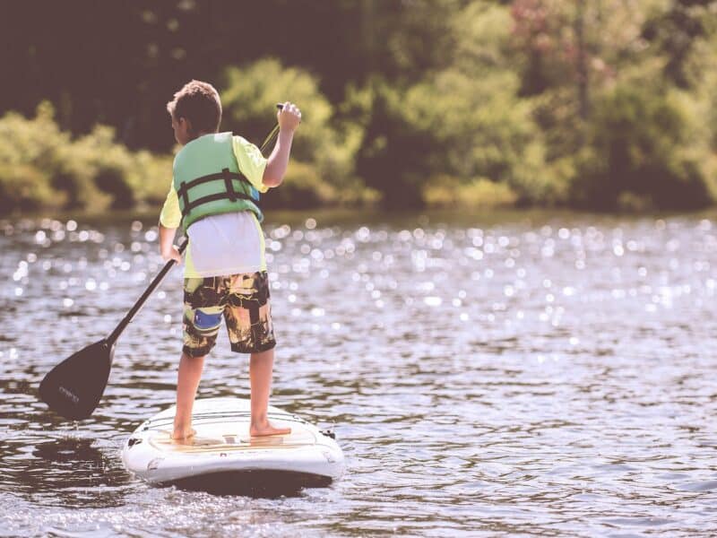 Paddle boarding with a life jacket.