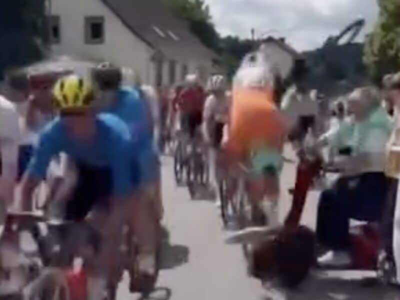 Elderly fan causes major crash with mobility scooter at junior cycling race.
