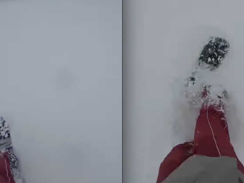 Snowboarder grabs June powder turns in Montana.
