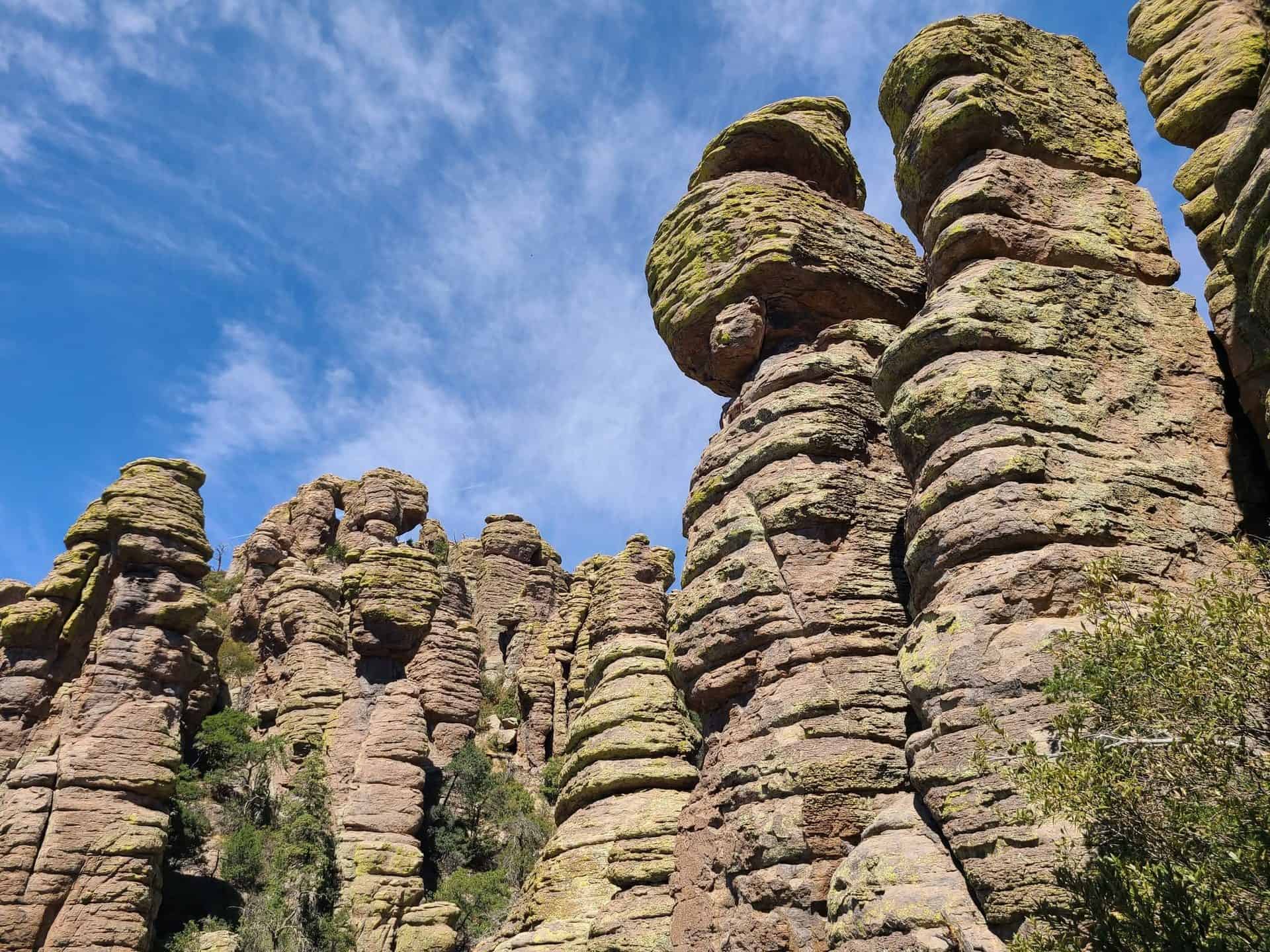 Distinctive rock formations under a blue sky in a mountain area.