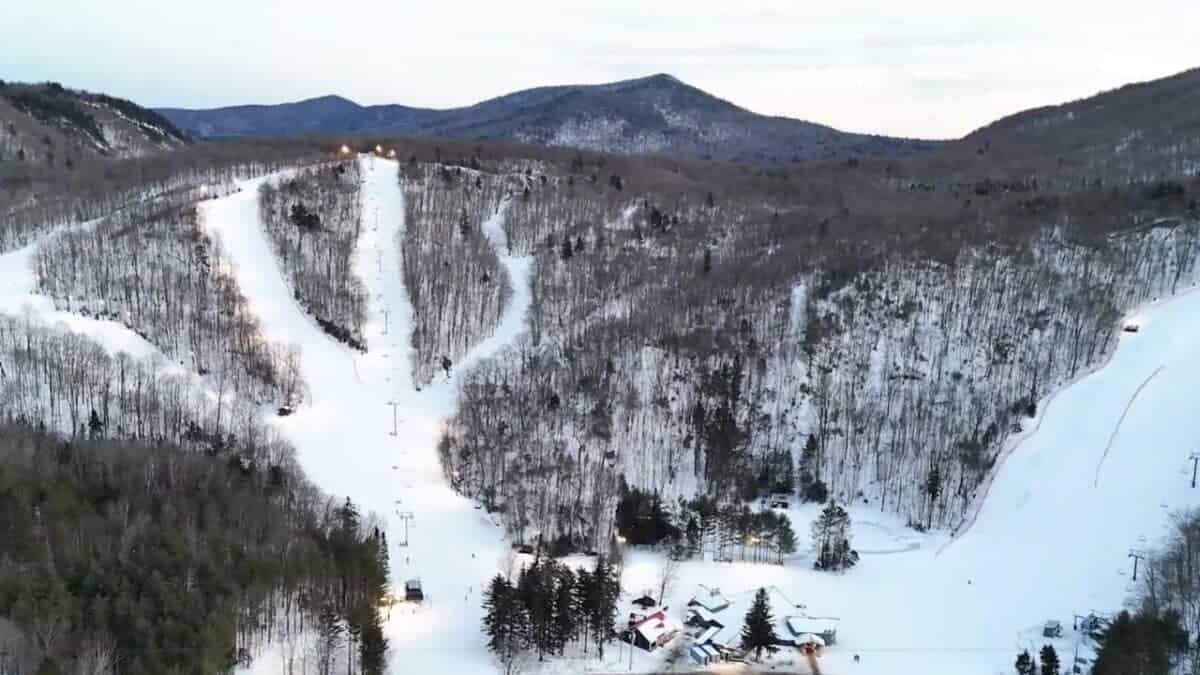 Snow-covered ski slopes and mountain landscape in Vermont during offseason.