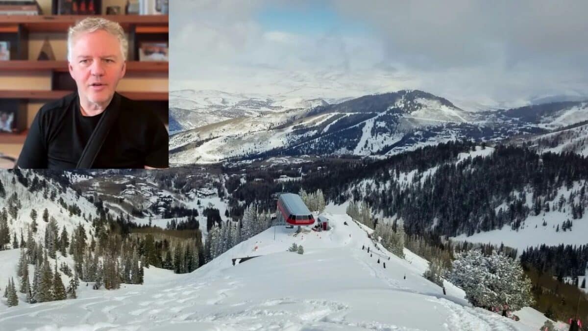 Scenic winter mountain view with ski lift and snow-covered trees.