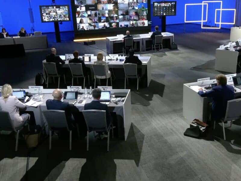 Business conference with participants at a large meeting room.