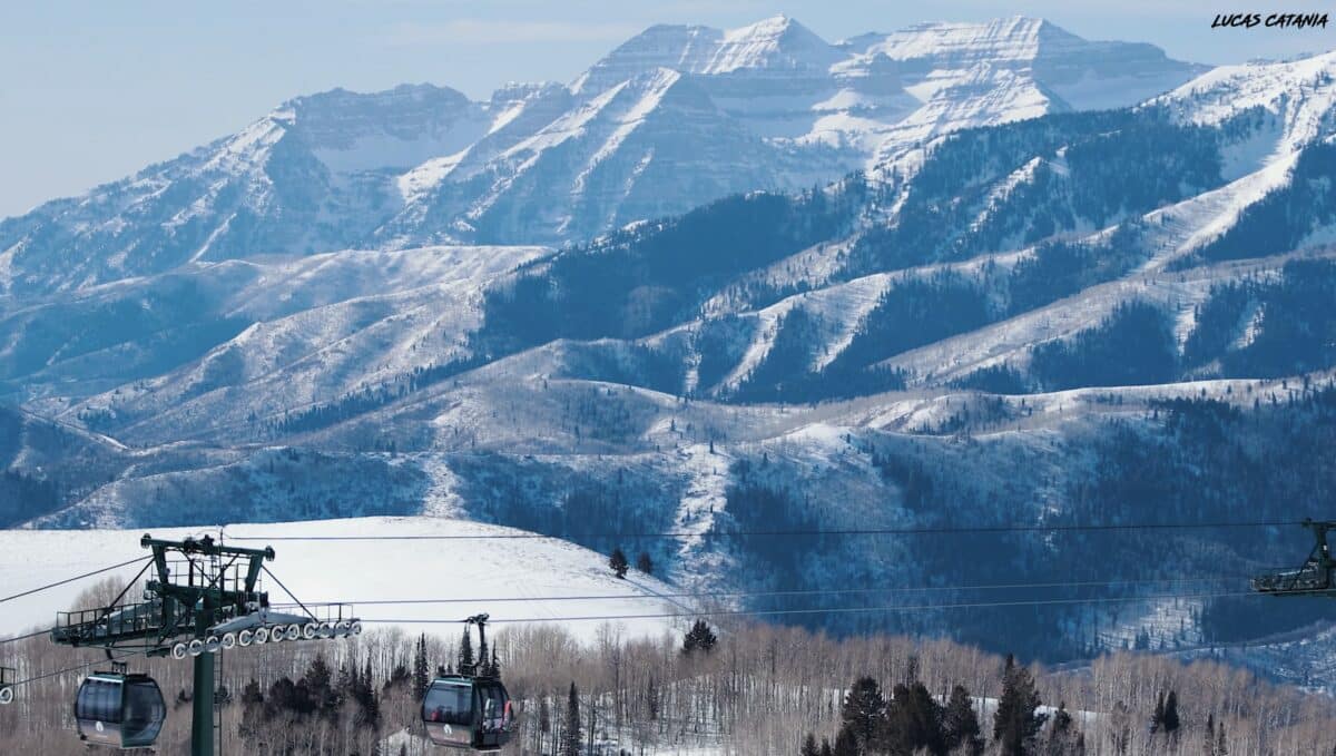 Snow-covered mountains with ski lifts and cable cars in a winter landscape.
