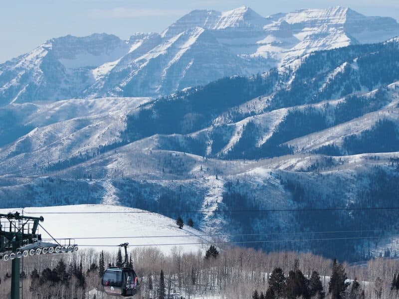 Snow-covered mountains with ski lifts and cable cars in a winter landscape.