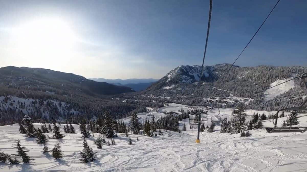 Snow-covered ski slopes and chairlift in a mountain resort in British Columbia.