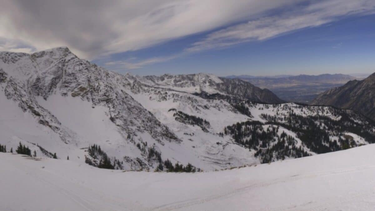 Snow-covered mountain landscape in Utah with clear blue sky.