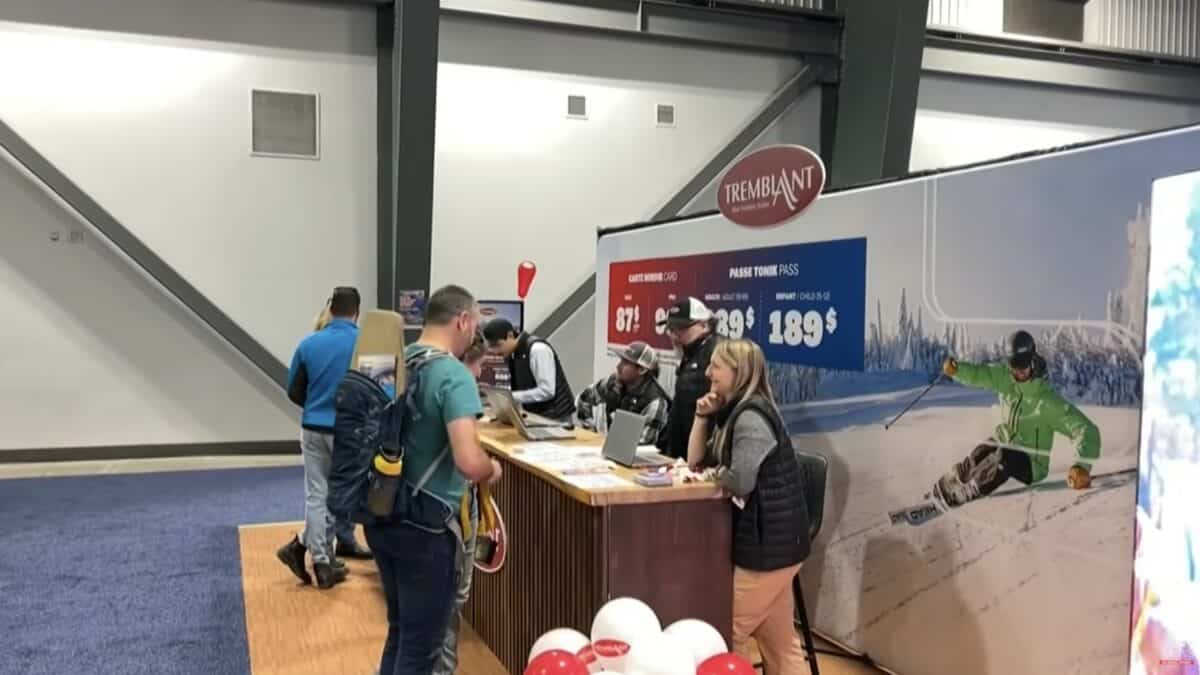 People checking in at airport with luggage and staff assisting.