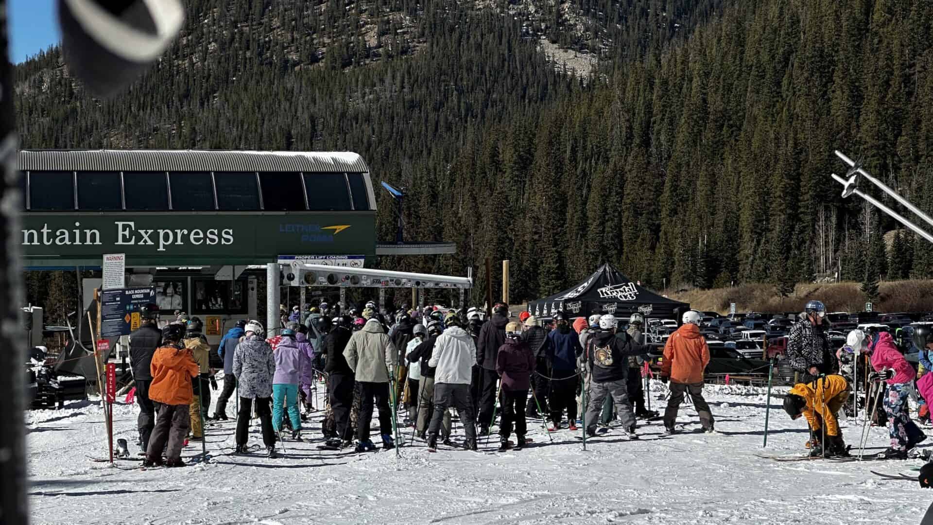 Skiers in line at Arapahoe Basin's Black Mountain Express chairlift.