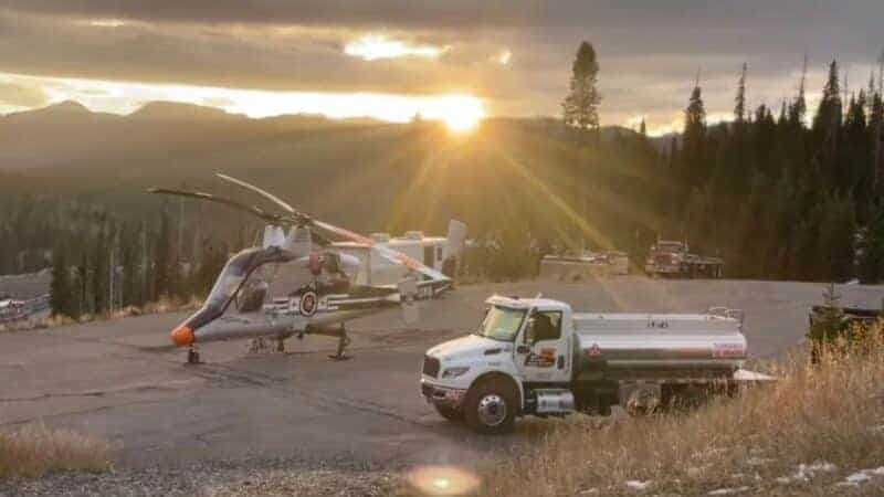 Rescue helicopter and support vehicle at Wolf Creek during sunset.