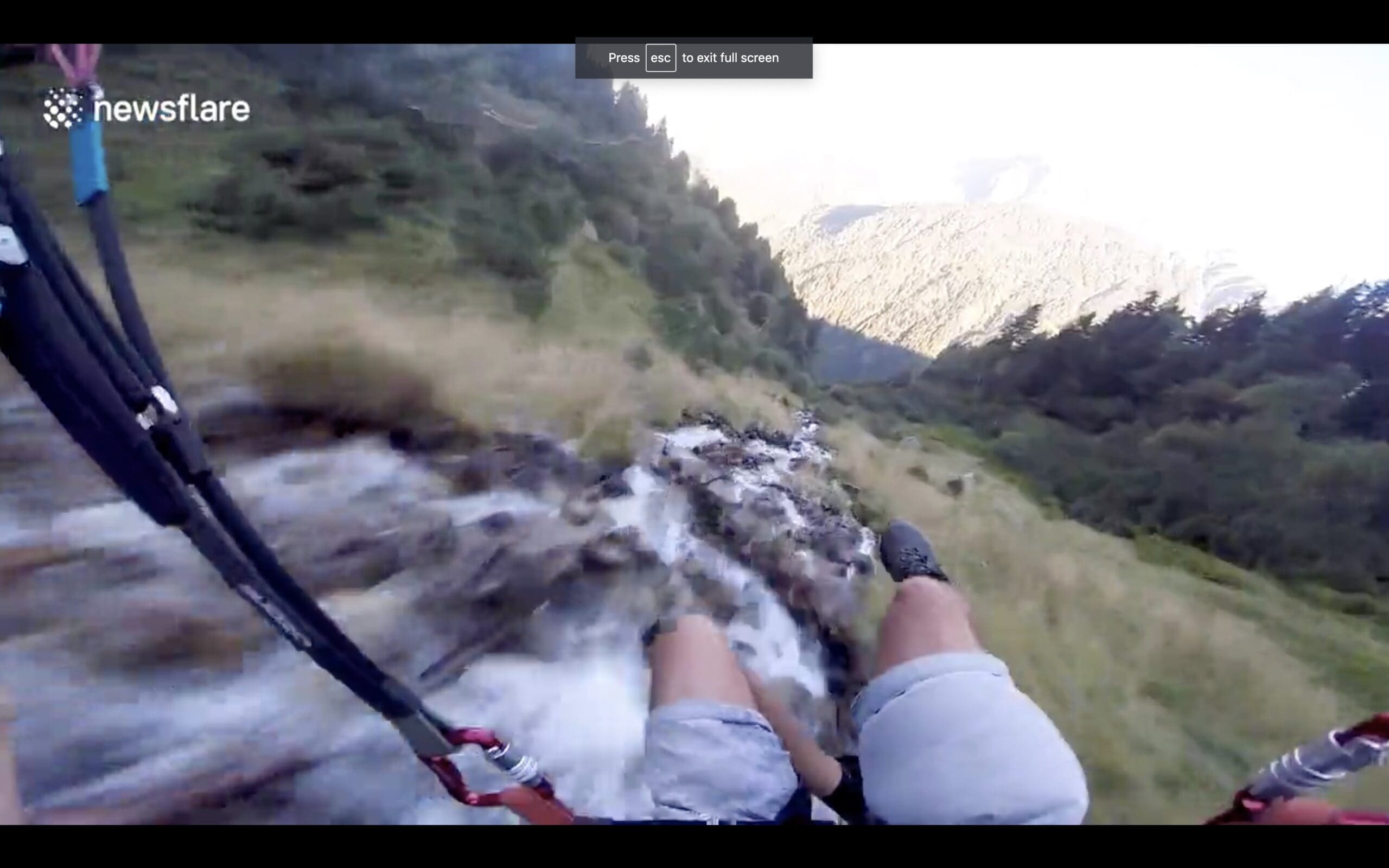 Speed flyer follows river down Austrian Alps inches away from treetops